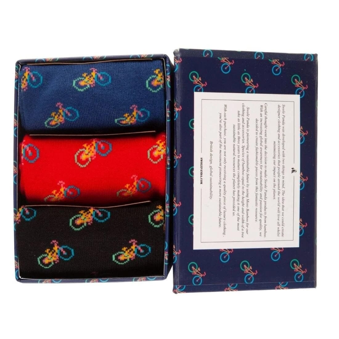 A three-pack of men's dress socks in navy, red, and black, each featuring a colorful pixelated bicycle pattern. The socks are presented in an open matching gift box next to the box lid, which features a white informational card.