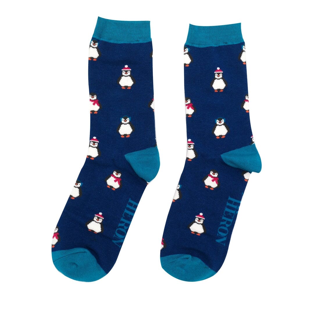 One pair of Mr Heron bamboo socks. They are blue with a lighter blue trim. They have penguins on.