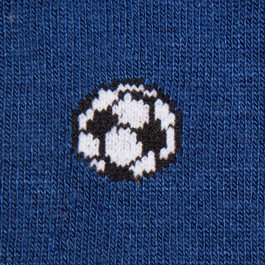 Close-up of a blue knit fabric with a white and black soccer ball pattern knitted into it.