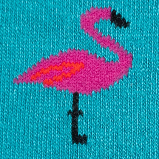 Close up of pink flamingo on a blue fabric background