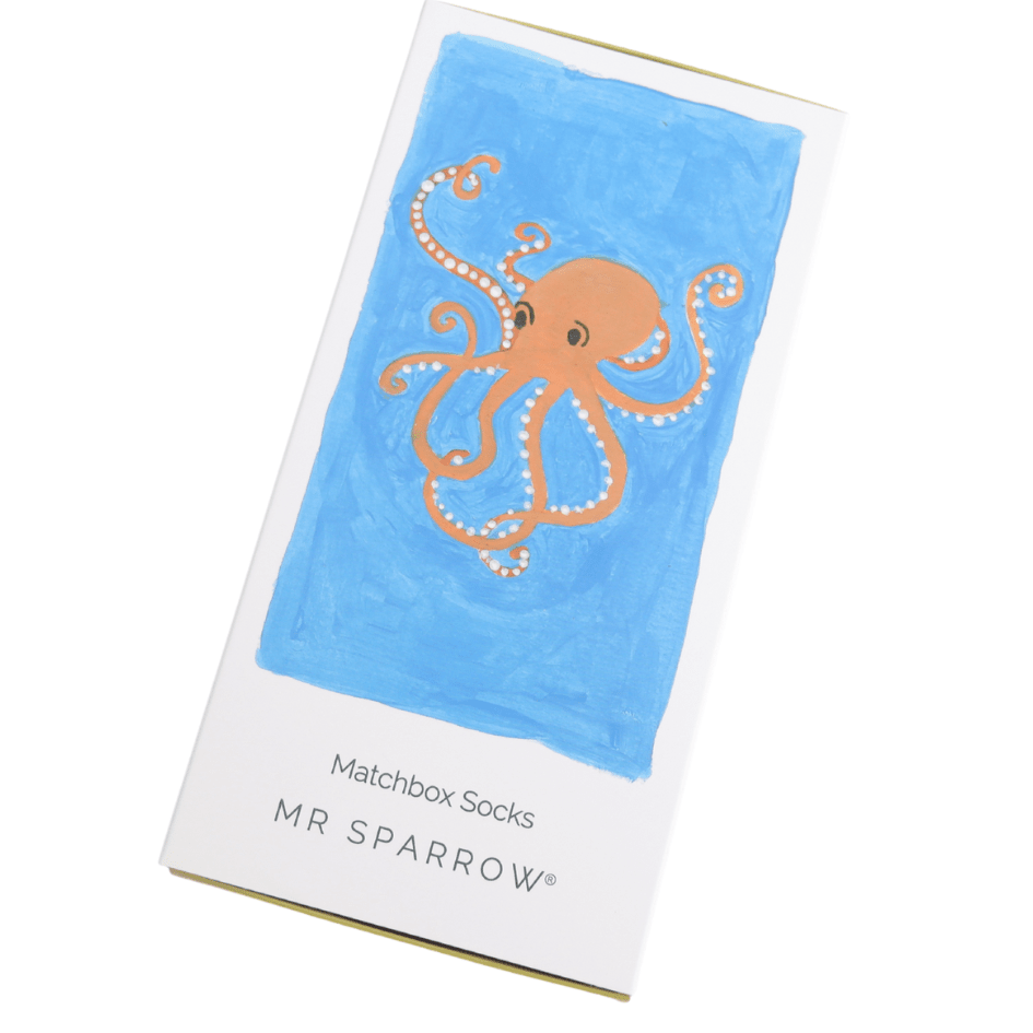 White box with an orange octobus desing on a blue background.  Below are the words matchbox socks, Mr Sprrow