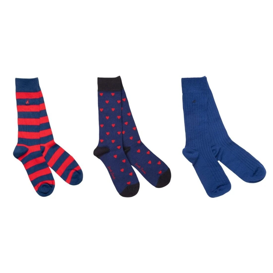 Three pairs of crew socks displayed side by side on a plain white background. The left pair features horizontal red and navy blue stripes, the middle pair has small red hearts on a navy blue background with black toes and heels, and the right pair is a solid royal blue ribbed knit.
