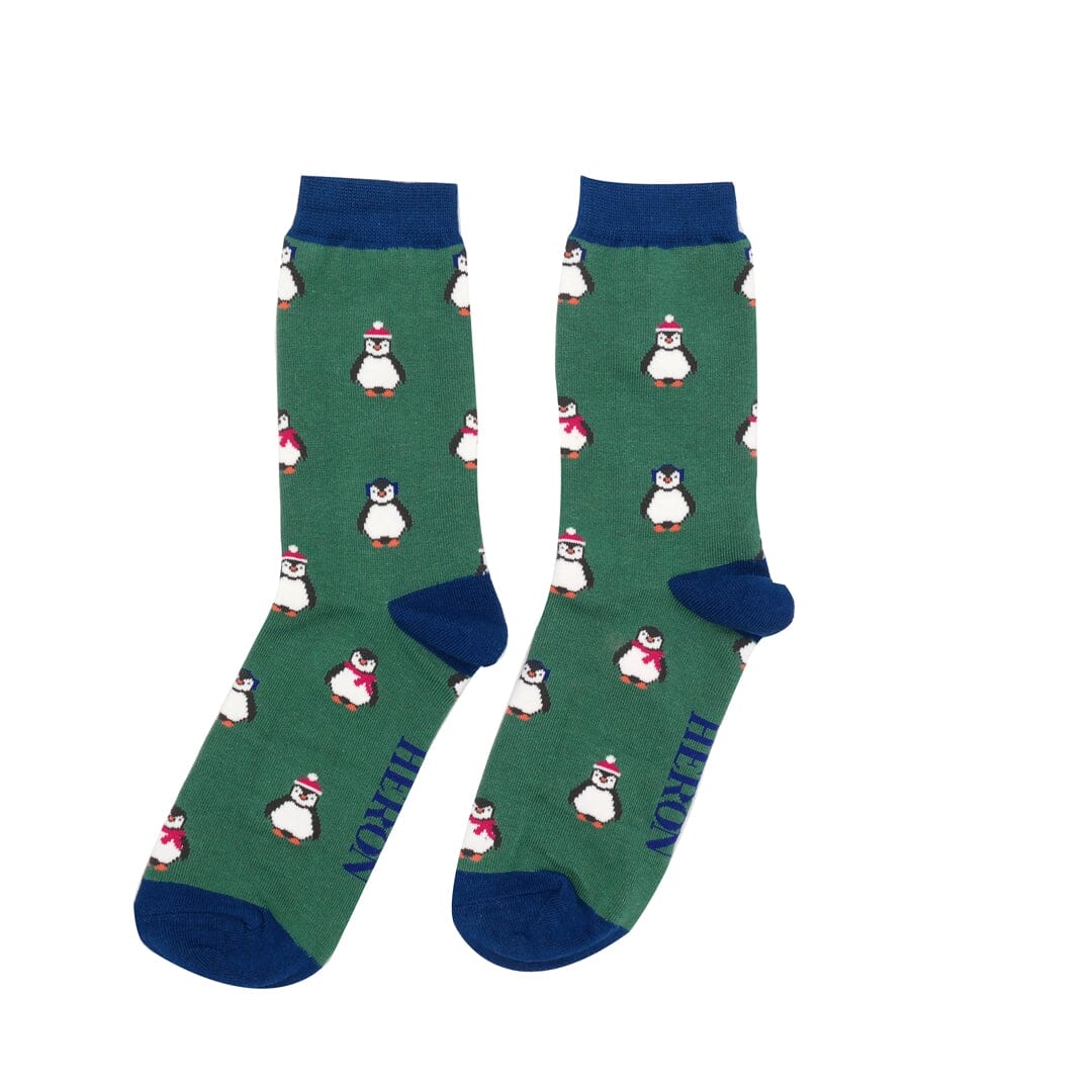 One pair of Mr Heron bamboo socks.  They are green with blue trim, and have penguins on. 