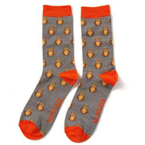 A pair of mens Mr Heron bamboo socks in grey with orange trim and owl design on them 
