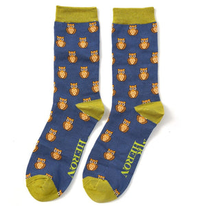 A pair of mens Mr Heron Bamboo Socks in Blue with green trim and an owl design on them