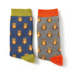 two pairs of mens Mr Heron bamboo socks, one get with orange trim, and one blue with green trim, both with a repeated owl design on them