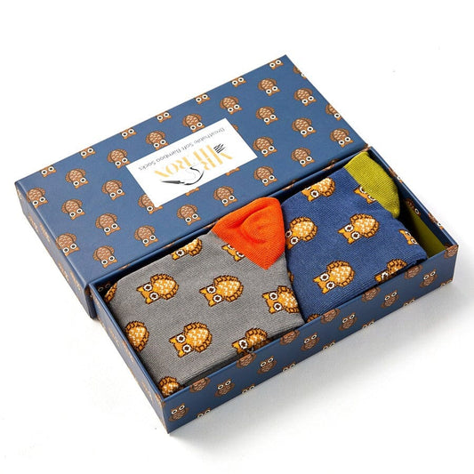 Two pairs of mens Mr Heron bamboo socks in a box with owl design. The box is open.