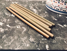 Load image into Gallery viewer, 6 bamboo straws lying on a black marble counter